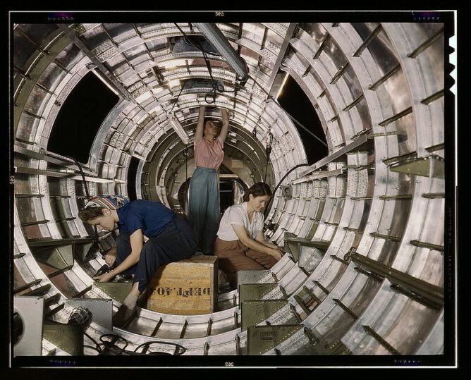 three women working inside the fuselage of an aircraft